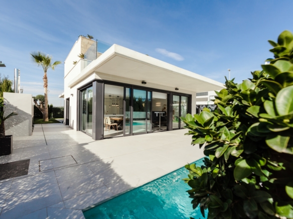 white and grey concrete building near swimming pool under clear sky during daytime